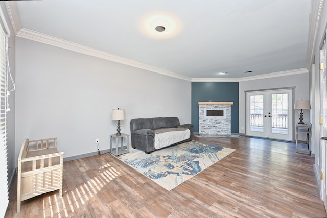 living room featuring hardwood / wood-style flooring, ornamental molding, and french doors