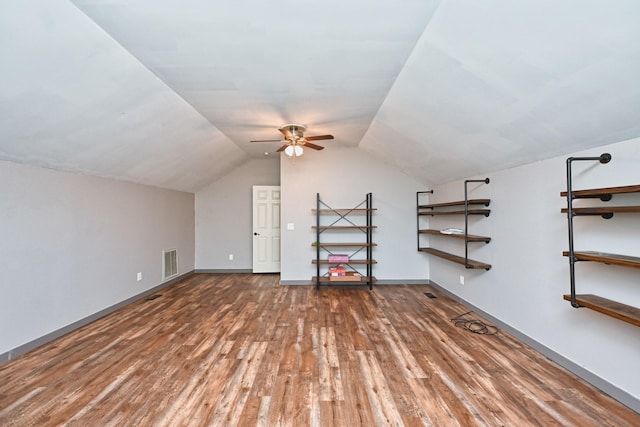 bonus room with dark wood-type flooring, ceiling fan, and vaulted ceiling