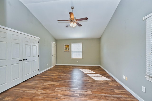 unfurnished bedroom with vaulted ceiling, dark hardwood / wood-style floors, and ceiling fan