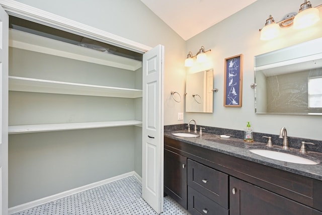 bathroom with vaulted ceiling and vanity