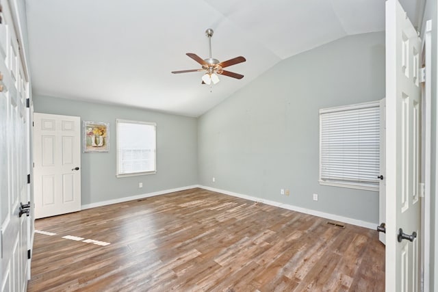 unfurnished room featuring ceiling fan, vaulted ceiling, and wood-type flooring