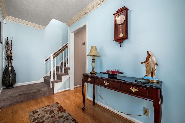 foyer entrance featuring a textured ceiling and light wood-type flooring