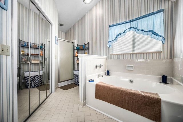 bathroom featuring independent shower and bath and tile patterned floors