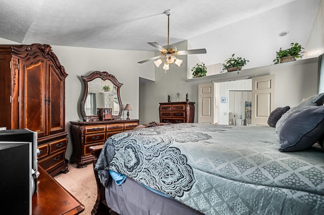 bedroom featuring vaulted ceiling, carpet floors, a textured ceiling, and ceiling fan