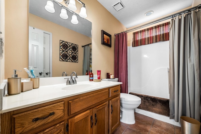 bathroom featuring vanity, tile patterned floors, and toilet