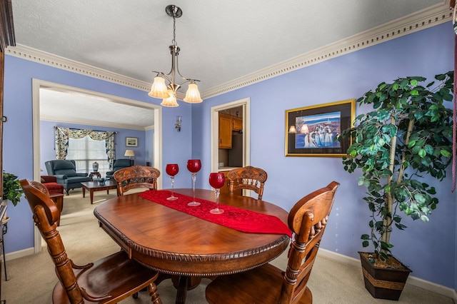 carpeted dining area with an inviting chandelier, ornamental molding, and a textured ceiling