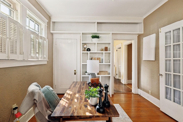 dining space with wood-type flooring and ornamental molding