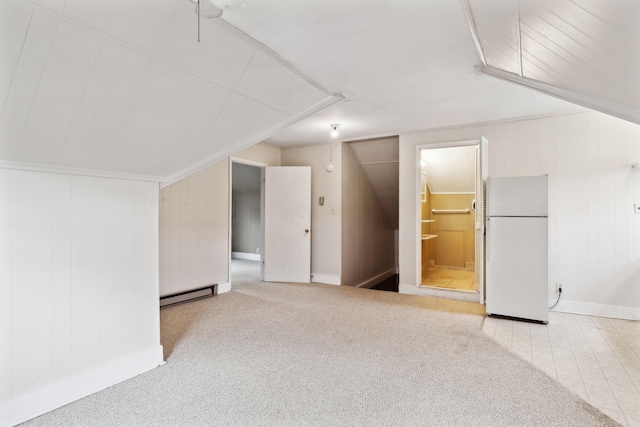 additional living space with a baseboard radiator and carpet floors