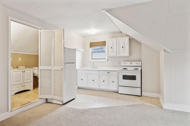 kitchen featuring white cabinetry, sink, light colored carpet, and white appliances