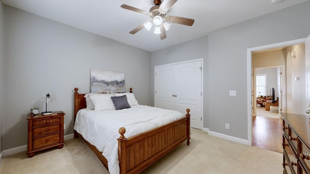 carpeted bedroom with a closet and ceiling fan