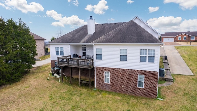 rear view of property featuring a wooden deck, a lawn, and central air condition unit