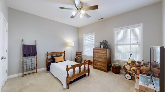 bedroom with light colored carpet and ceiling fan