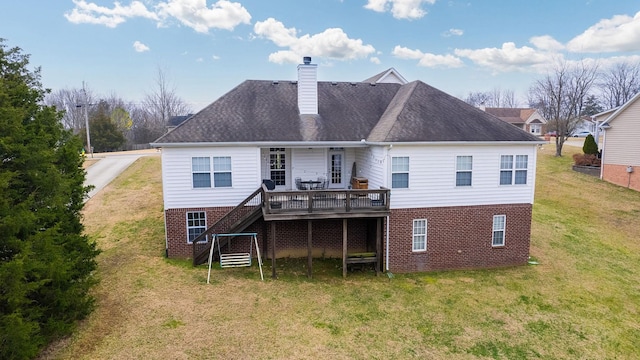 back of house featuring a wooden deck and a yard