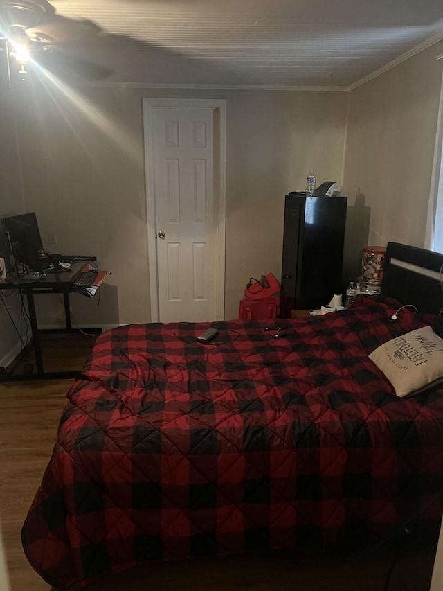 bedroom featuring crown molding and hardwood / wood-style flooring