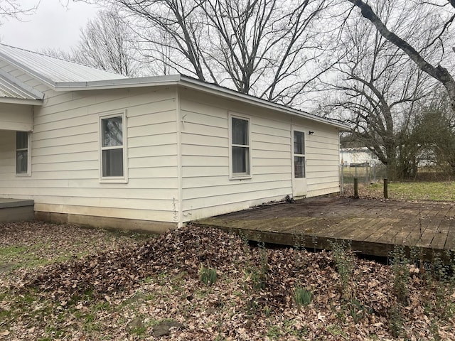 view of side of home featuring a wooden deck