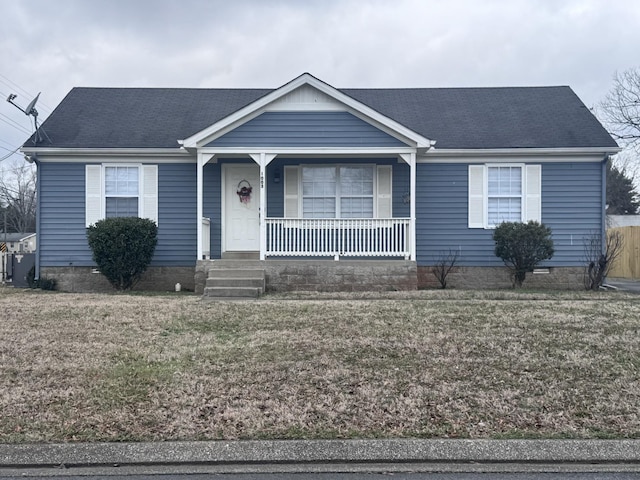 ranch-style home with covered porch and a front lawn