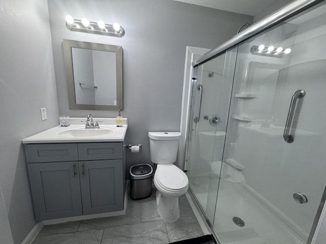 bathroom with a shower with door, vanity, and toilet