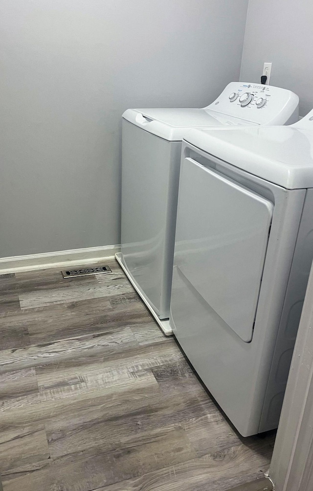 1003 Tyler Dr, Murfreesboro, TN 37130 - washroom featuring washing machine and clothes dryer and wood finished floors