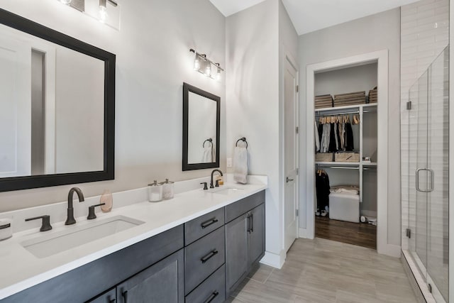 bathroom featuring vanity and an enclosed shower