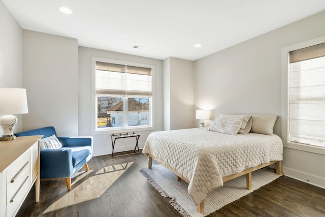 bedroom featuring dark hardwood / wood-style floors and multiple windows