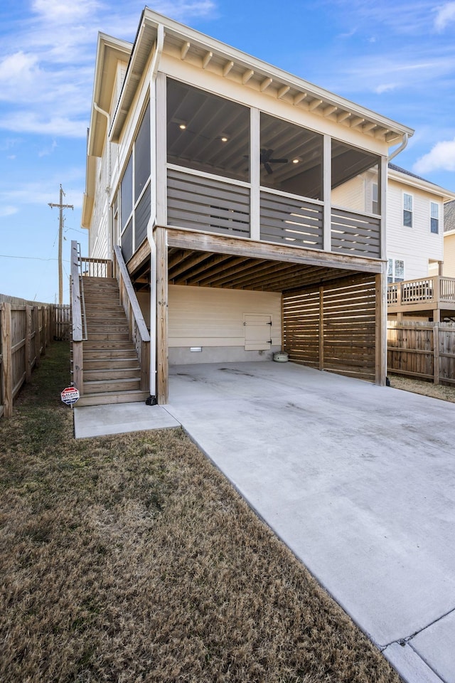 rear view of property with a carport and a sunroom