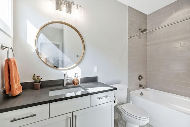 full bathroom with vanity, toilet, and tiled shower / bath