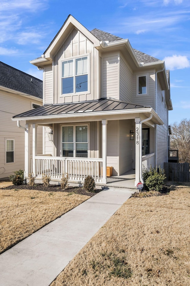 view of front of home featuring covered porch and a front lawn