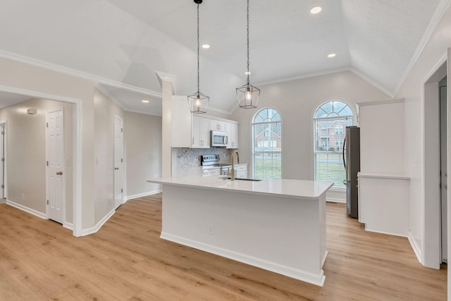 kitchen with vaulted ceiling, appliances with stainless steel finishes, tasteful backsplash, white cabinetry, and hanging light fixtures