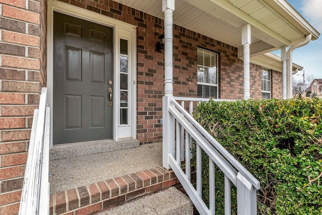 view of exterior entry with a porch