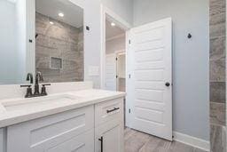 bathroom with vanity and hardwood / wood-style floors