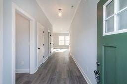 corridor featuring dark hardwood / wood-style flooring