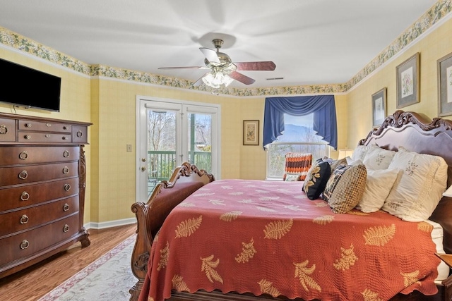 bedroom with hardwood / wood-style flooring, access to outside, french doors, and ceiling fan