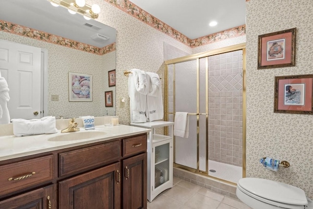 bathroom with vanity, tile patterned floors, toilet, and walk in shower