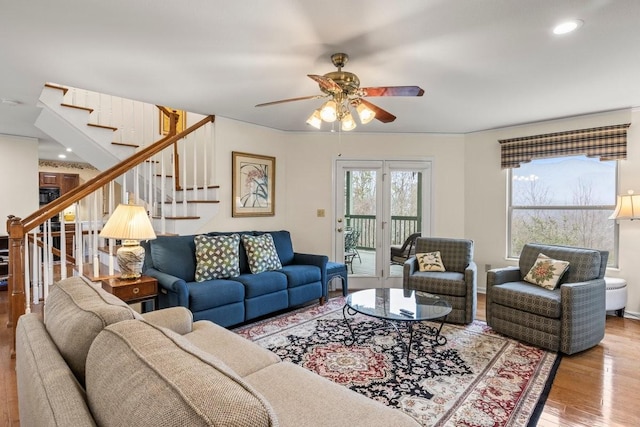 living room featuring hardwood / wood-style flooring and ceiling fan