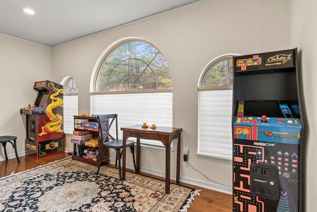 rec room featuring ornamental molding and hardwood / wood-style floors