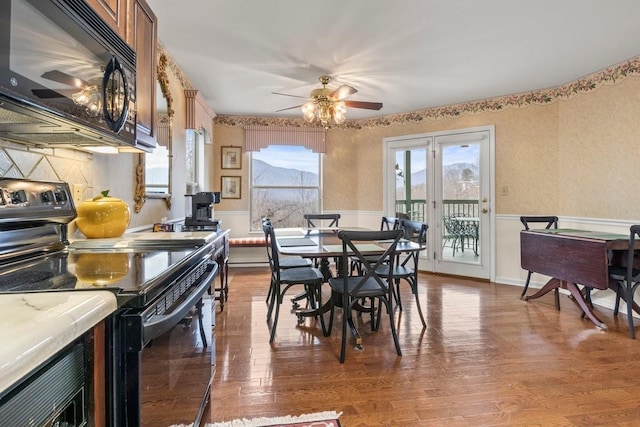 dining room with wood-type flooring and ceiling fan