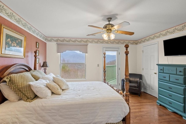 bedroom featuring hardwood / wood-style floors, access to outside, and ceiling fan