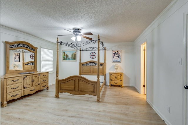 bedroom with light hardwood / wood-style flooring, ornamental molding, and a textured ceiling