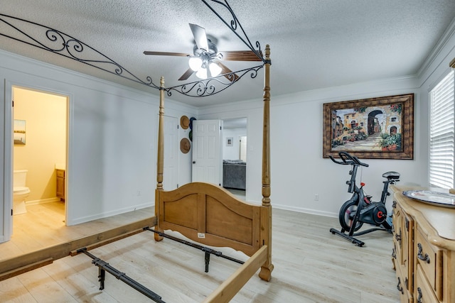 bedroom featuring crown molding, a textured ceiling, and light hardwood / wood-style floors