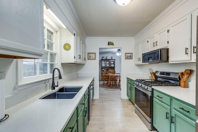 kitchen featuring white cabinetry, sink, ornamental molding, green cabinets, and black appliances