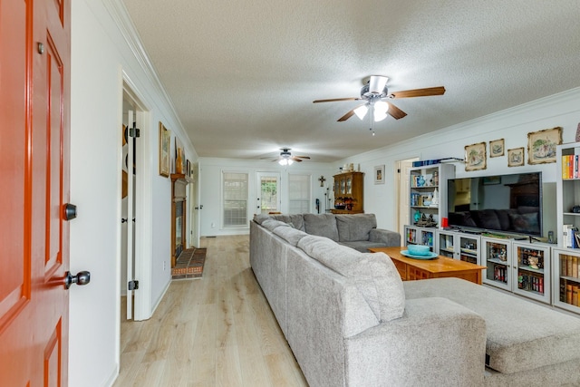 living room featuring ornamental molding, ceiling fan, a textured ceiling, and light wood-type flooring