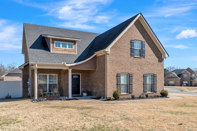 front of property featuring a front yard and covered porch