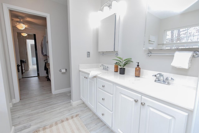 bathroom with vanity, hardwood / wood-style floors, and ceiling fan