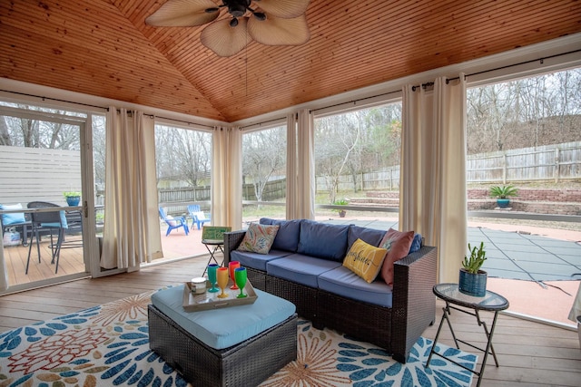 sunroom with ceiling fan, vaulted ceiling, and wooden ceiling