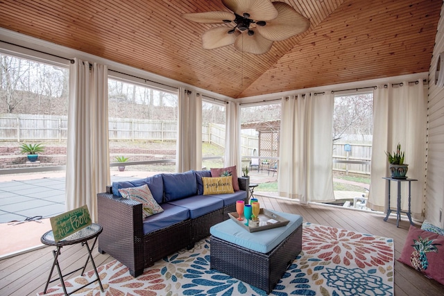 sunroom / solarium with vaulted ceiling, wooden ceiling, and ceiling fan