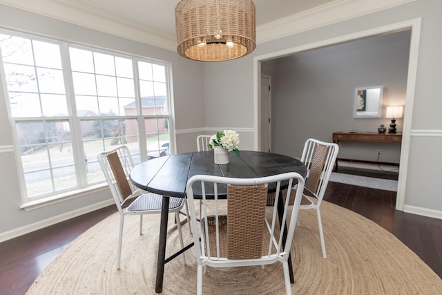 dining space with crown molding, a notable chandelier, and dark hardwood / wood-style flooring