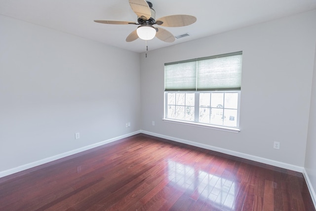 unfurnished room with dark wood-type flooring and ceiling fan