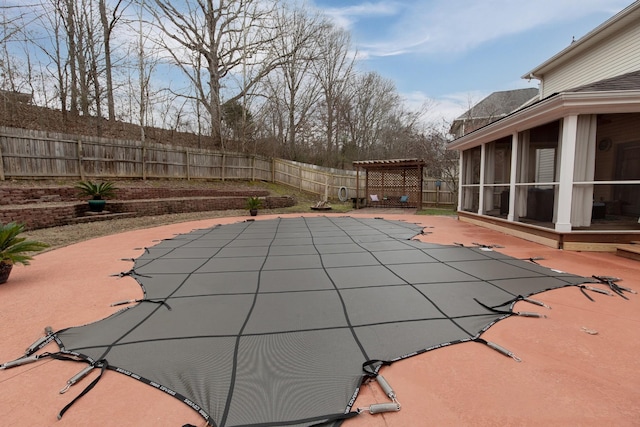 view of pool with a sunroom, a pergola, and a patio