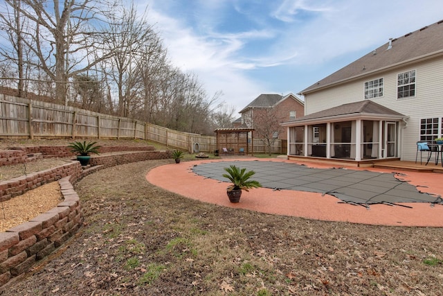 view of swimming pool with a sunroom and a patio area