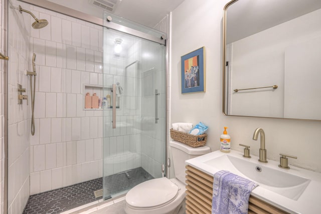 bathroom with vanity, toilet, and an enclosed shower